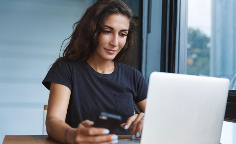 Girl Using Laptop And Phone