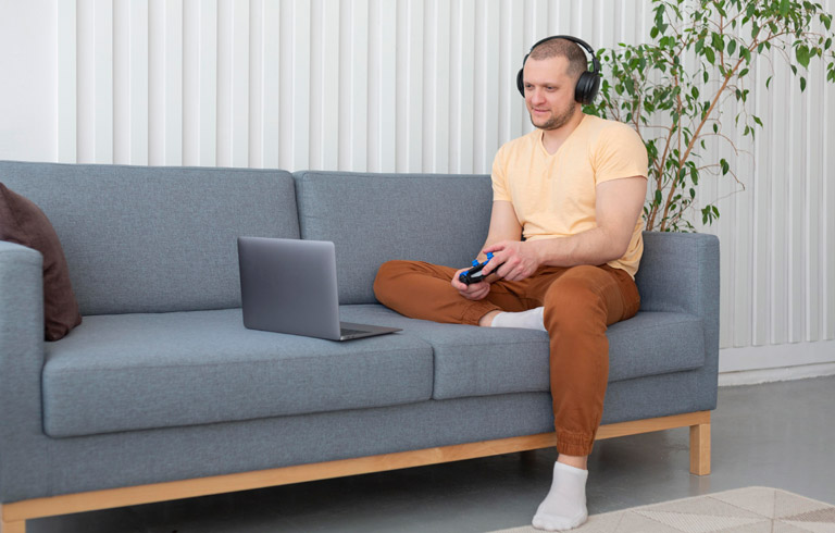 Man Playing Videogame On His Laptop